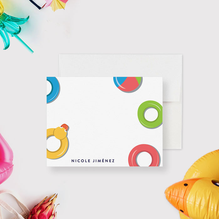 Personalized pool party thank you card with colorful swim rings, a yellow duck float, a beach ball and a name on a white front.