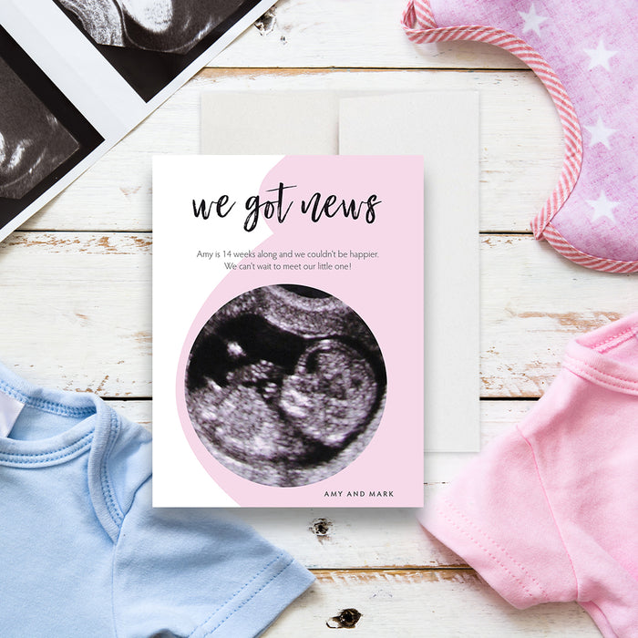 Personalized pregnancy announcement card with ultrasound photo, “we got news” message, soft pink design and custom parents’ names-front