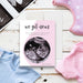 Personalized pregnancy announcement card with ultrasound photo, “we got news” message, soft pink design and custom parents’ names-front