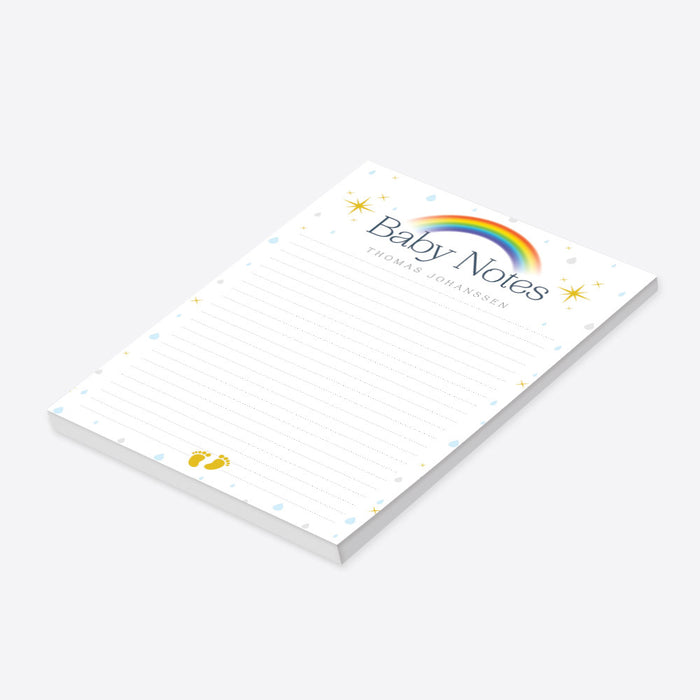 Personalized lined baby notepad with colorful rainbow, blue and gray raindrops, yellow stars, baby footprints, Baby Notes heading and custom name-side