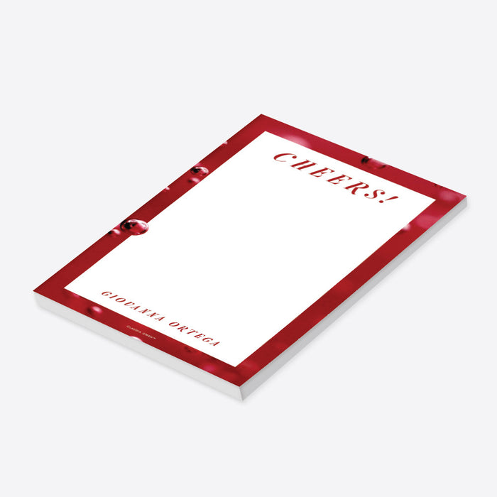 personalized red cocktail party notepad with Cheers wording, bubbly drink-inspired border, custom name, and blank writing space-side
