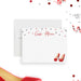 Personalized note card with red high heels, red and black confetti and a name in red script, shown with a white envelope.