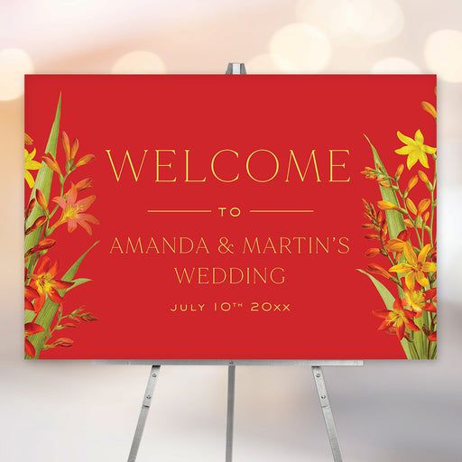 Personalized red tropical floral wedding welcome sign with orange and yellow flowers, custom couple’s names and wedding date