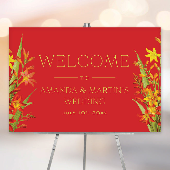 Personalized red tropical floral wedding welcome sign with orange and yellow flowers, custom couple’s names and wedding date