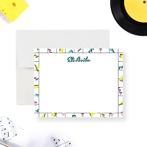Personalized note card with a white writing area surrounded by a colorful geometric Memphis pattern with a name at the top. Shown with a white envelope.