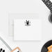 Personalized note card with a black rock hand gesture, lightning bolts and a personalized name, shown with a white envelope.