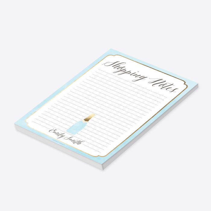 Personalized lined shopping list notepad with Shopping Notes heading, custom name, pale blue border and small champagne bottle-side