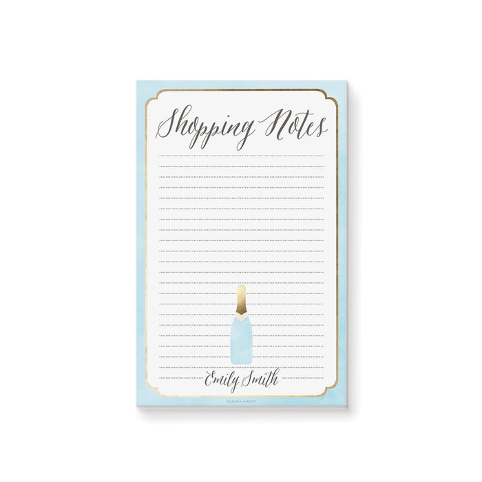 Personalized lined shopping list notepad with Shopping Notes heading, custom name, pale blue border and small champagne bottle