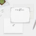 Personalized white note cards with a silver-colored deer outline, script name and decorative silver-colored border.
