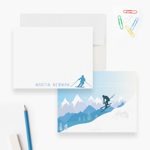 Personalized white note card with a small blue skier and a reverse showing a skier on snowy mountain slopes.
