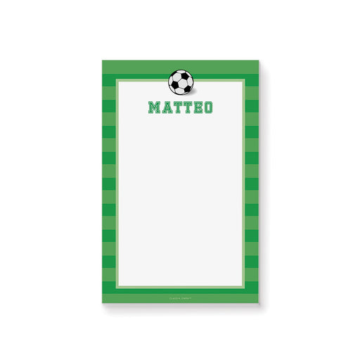 Personalized soccer notepad with a black-and-white soccer ball, green striped border, custom name, and a large white writing area.