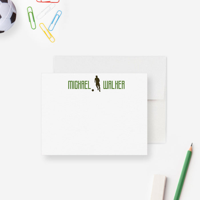 Personalized note card with a soccer player silhouette and a personalized name in green, shown with a white envelope.