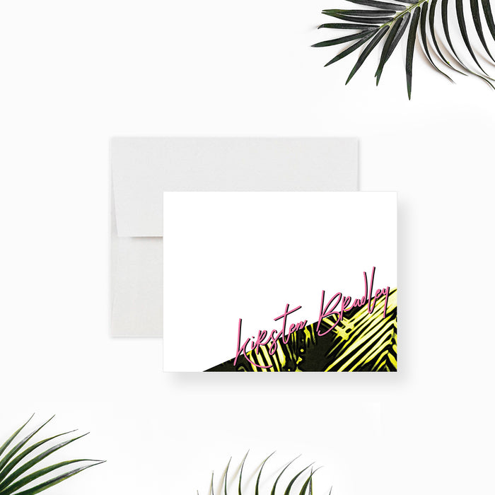 Personalized white note card with green palm leaf illustrations in the lower right corner and a pink script name.