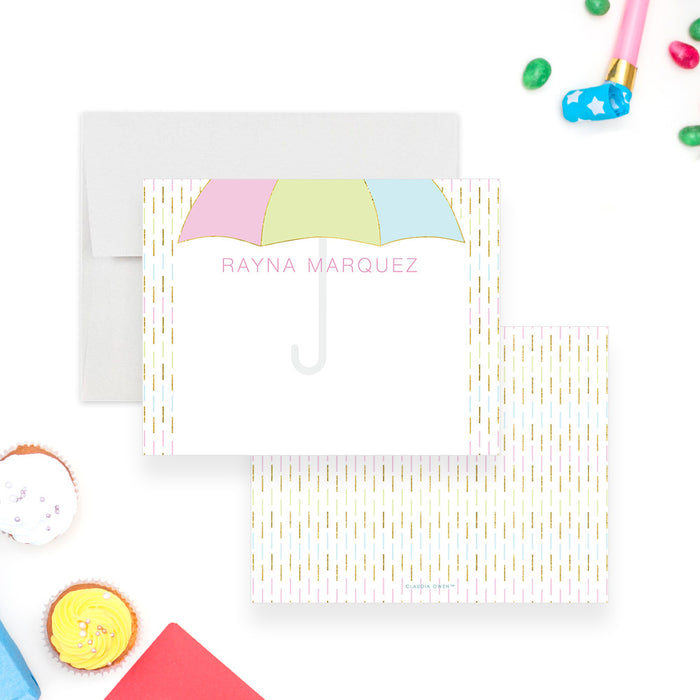 Personalized Umbrella Baby Shower Thank You Cards. Front and matching pastel raindrop pattern on a white back displayed with a white envelope.