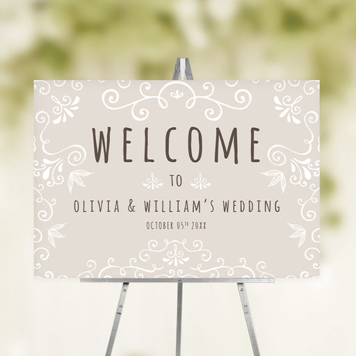 Personalized vintage wedding welcome sign with taupe background, white ornamental details, couple names and wedding date