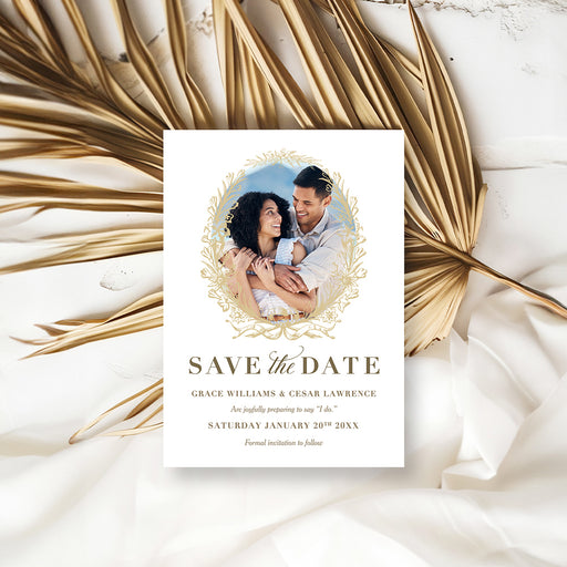 Wedding save the date card with a couple photo framed by a gold floral wreath, personalized names and wedding date-front