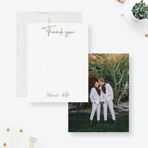 Personalized white wedding thank you note cards with script names on the front and a couple's photo on the reverse.