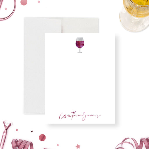 Personalized note card with a white portrait front with a red wine glass illustration and personalized script name. Shown with a white envelope.