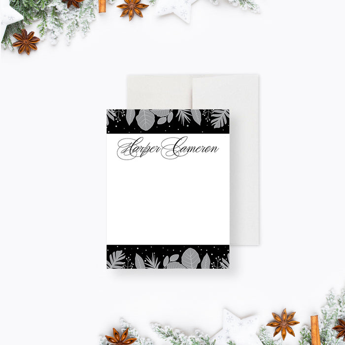 personalized winter botanical note card with custom name, gray foliage accents, black and white design, and blank writing space-front