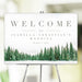 Personalized winter wedding welcome sign with snowy pine tree forest, custom couple’s names and December wedding date