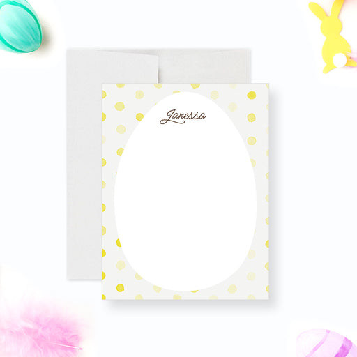 Personalized note card with a white front with yellow polka dots, an egg-shaped writing area, and a name in script. Shown with a white envelope.