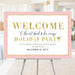 pink and gold holiday welcome sign with elegant typography and modern cocktail party design on easel display