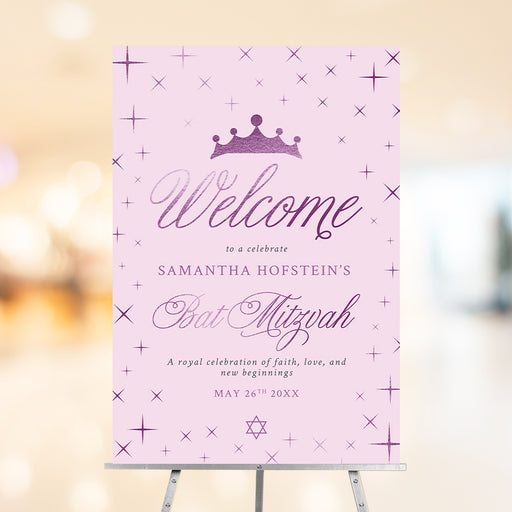 Bat mitzvah welcome sign in pink and purple with princess crown, star accents, and elegant script text for a party entrance display.