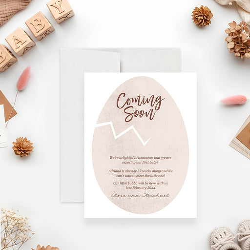 personalized coming soon baby announcement card featuring a neutral cracked egg illustration with custom pregnancy announcement wording-front