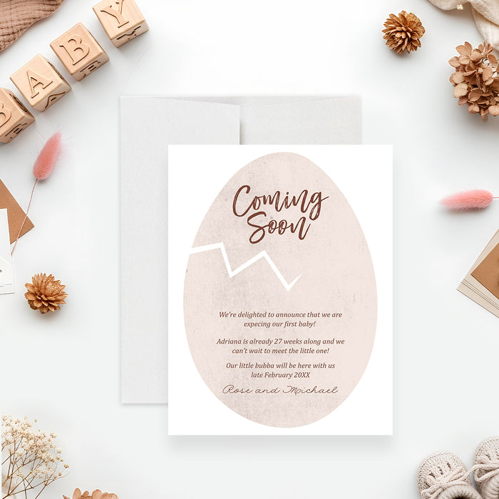 personalized coming soon baby announcement card featuring a neutral cracked egg illustration with custom pregnancy announcement wording-front
