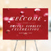 red cocktail party welcome sign with Drinks and Nibbles wording, bubbly drink-inspired background, and custom celebration details
