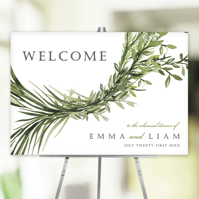 Rehearsal dinner welcome sign featuring a delicate arrangement of green botanical foliage, perfect for wedding entrance decor and photo backdrop displays