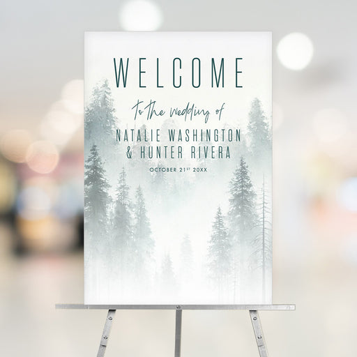 Elegant misty forest wedding welcome sign with personalized names and date, featuring soft pine trees and a romantic woodland theme.
