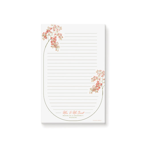 Custom floral wedding notepad featuring blush and coral blossoms, a botanical frame, lined pages, and personalized names—ideal for weddings or bridal showers.