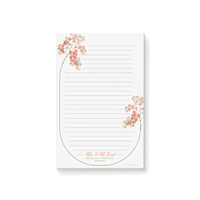 Custom floral wedding notepad featuring blush and coral blossoms, a botanical frame, lined pages, and personalized names—ideal for weddings or bridal showers.