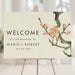 Cherry blossom welcome sign with customizable names and date, elegant floral event signage for weddings and celebrations.