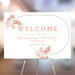 Elegant blush and coral floral wedding welcome sign with a curved botanical frame, personalized for weddings, parties, and milestone events.