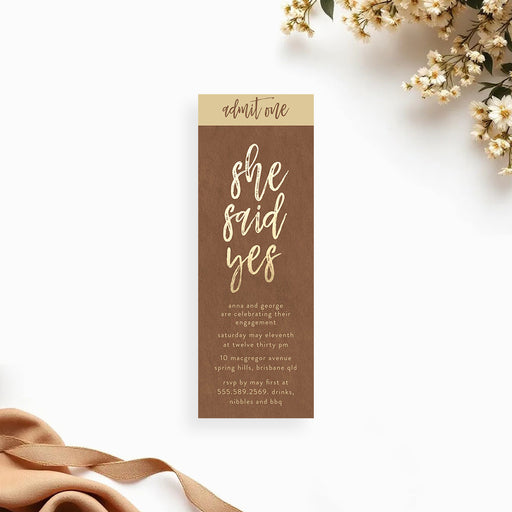 Rustic brown and gold she said yes ticket invitation for engagement party with elegant script lettering.