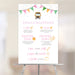 Personalized school bus first birthday milestone sign featuring colorful bunting, baby milestones, favorite foods, favorite books, height, weight, and birthday party decoration displayed on an easel.