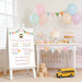 Personalized school bus first birthday milestone sign featuring colorful bunting, baby milestones, favorite foods, favorite books, height, weight, and birthday party decoration displayed on an easel.