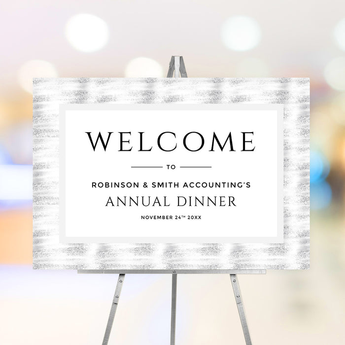 corporate annual dinner welcome sign with black and white formal layout, textured gray border, company name, and event date displayed on an easel