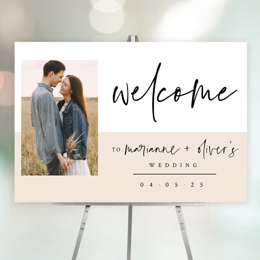 Modern wedding welcome sign featuring the couple's photo, their names, and wedding date in elegant script and neutral tones.