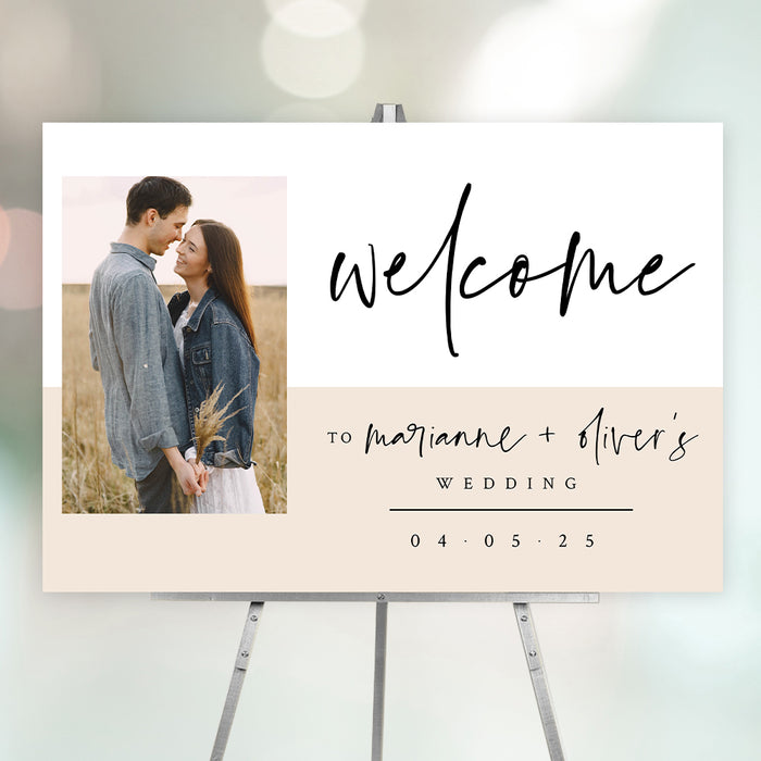 Modern wedding welcome sign featuring the couple's photo, their names, and wedding date in elegant script and neutral tones.