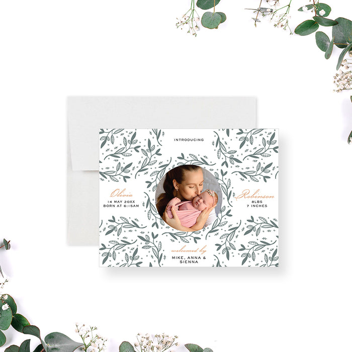 Botanical baby announcement card with circular newborn photo and green leafy pattern-front
