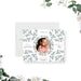 Botanical baby announcement card with circular newborn photo and green leafy pattern-front