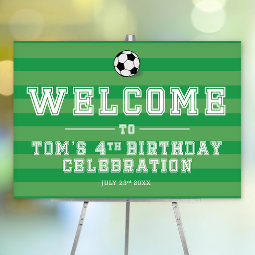 Green soccer birthday welcome sign with a black and white soccer ball, striped background, and personalized party details