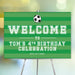 Green soccer birthday welcome sign with a black and white soccer ball, striped background, and personalized party details