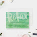 Spa birthday invitation template with green watercolor background and “relax” lettering, designed for pamper party and spa day celebrations.