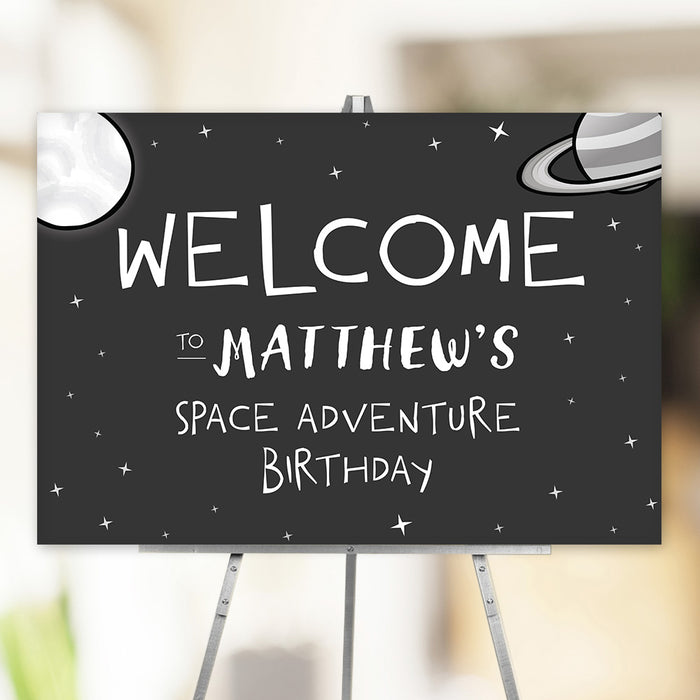 Space adventure birthday party welcome sign featuring a moon, planets, and twinkling stars