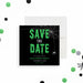 Halloween save the date card featuring green dripping text, a spider web design, and a spider graphic on a black background.-front