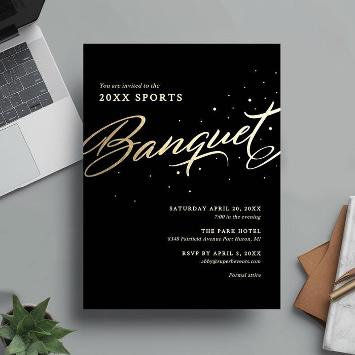 Sports banquet invitation card on a gray surface with a laptop and stationery items.